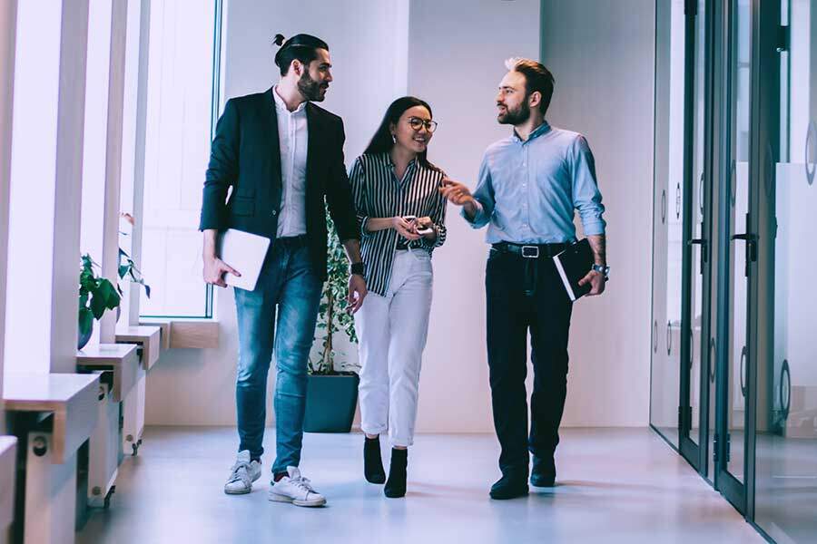 business group walking in office corridor