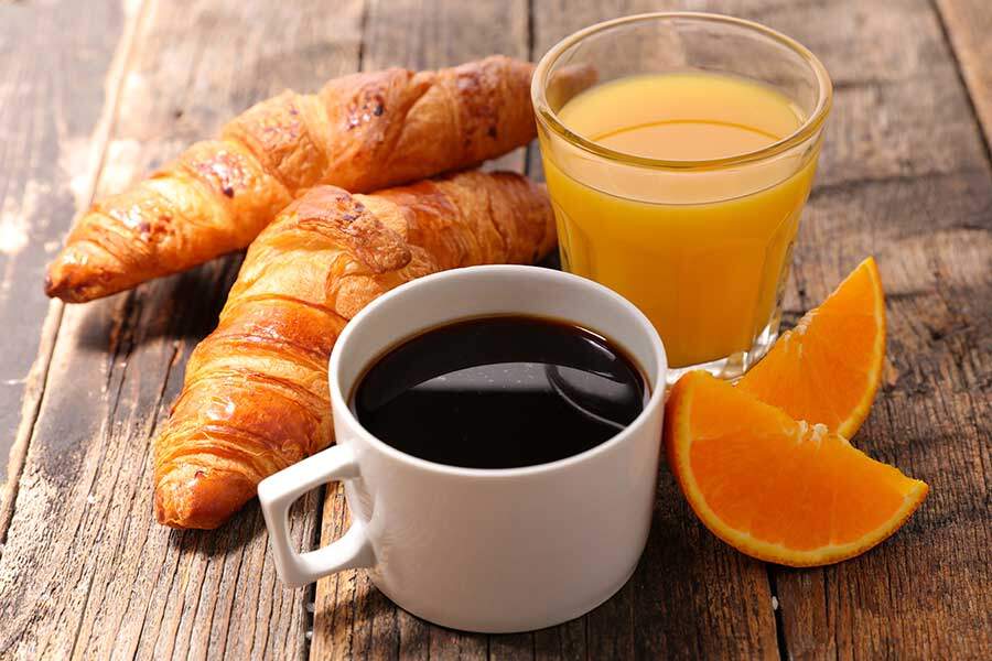 coffee cup with croissant and orange juice